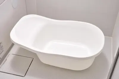 a white toilet in a bathroom with a white wall at Sakura in Tokyo