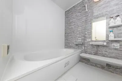 a bathroom with a bath tub and a sink at Sakura in Tokyo