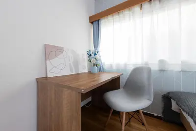 a desk with a chair next to a window at Sakura in Tokyo