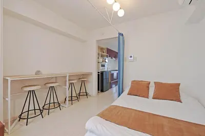 a bedroom with a bed and a counter with stools at V Close to Kikukawa sta 14 min to Akihabara in Tokyo
