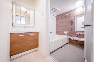 a bathroom with a tub and a sink and a toilet at Ikebukuro Japandi Villa in Tokyo