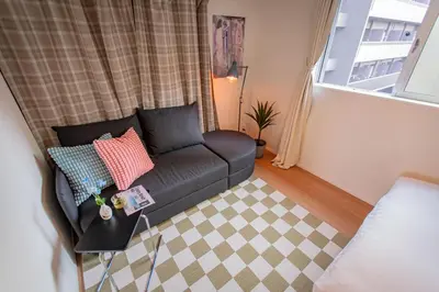 a living room with a couch and a window at Ikebukuro Japandi Villa in Tokyo