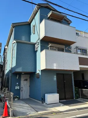 a blue building on a city street at Lapis House 101 & 201 in Tokyo