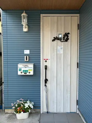 a blue house with a door with a bow at Lapis House 101 & 201 in Tokyo