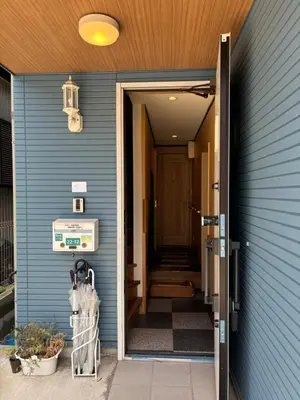 an open door to a house with a blue siding at Lapis House 101 & 201 in Tokyo