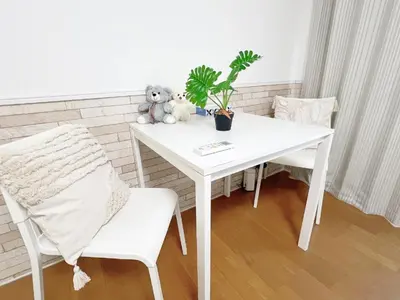a white table with a teddy bear and a plant on it at Takadanobaba RedH in Tokyo