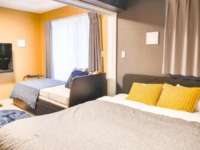 a hotel room with two beds and a window at Triphome Asakusa Alpha 2025 in Tokyo