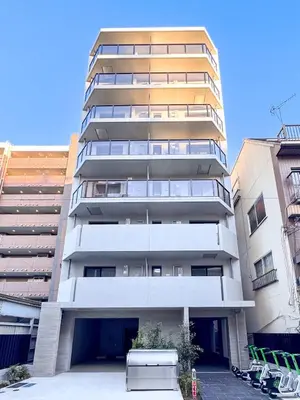 a tall apartment building in front of two buildings at Triphome Asakusa Alpha 2025 in Tokyo