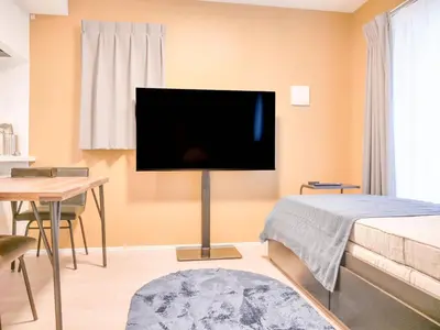 a living room with a flat screen tv on the wall at Triphome Asakusa Alpha 2025 in Tokyo