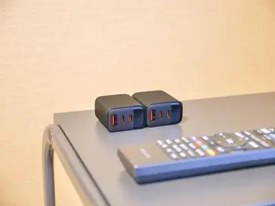 two remote controls sitting on top of a table at Triphome Asakusa Alpha 2025 in Tokyo