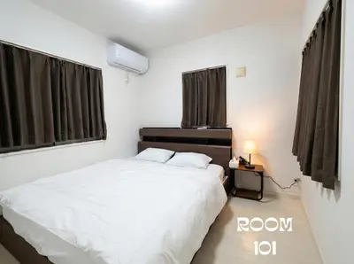 a bedroom with a white bed and a night stand at MEME Villa 5BR - 3 Separate Toilets & 3 Showers - 10Gbps Wifi in Tokyo