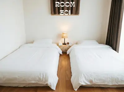 a room with two beds and a table with a lamp at MEME Villa 5BR - 3 Separate Toilets & 3 Showers - 10Gbps Wifi in Tokyo
