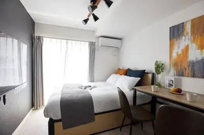 a hotel room with a bed and a desk with a desk at \u30e1\u30be\u30f3\u30cf\u30a4\u30a6\u30a7\u30a4\u6c60\u888b in Tokyo