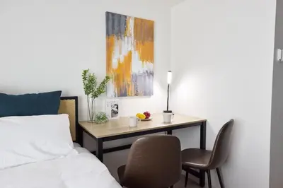 a bedroom with a desk and a bed with a table and chairs at \u30e1\u30be\u30f3\u30cf\u30a4\u30a6\u30a7\u30a4\u6c60\u888b in Tokyo