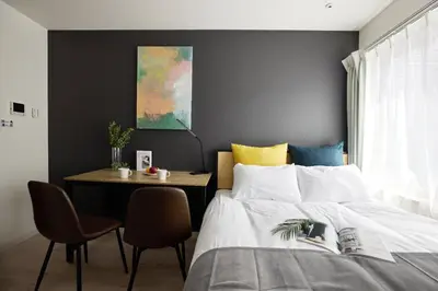 a bedroom with a bed and a table with a chair at \u30e1\u30be\u30f3\u30cf\u30a4\u30a6\u30a7\u30a4\u6c60\u888b in Tokyo