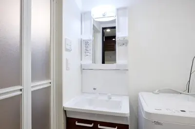 a white bathroom with a sink and a mirror at \u30e1\u30be\u30f3\u30cf\u30a4\u30a6\u30a7\u30a4\u6c60\u888b in Tokyo