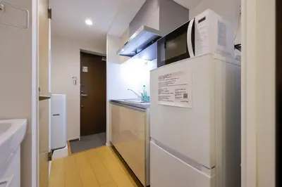 a small kitchen with a refrigerator and a sink at \u30ea\u30d0\u30c6\u30a3 in Tokyo