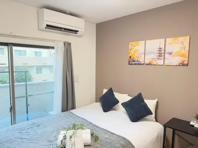 a bedroom with a white bed and a window at Ikebukuro Area 2 Units 2122 KamiikeApartment in Tokyo