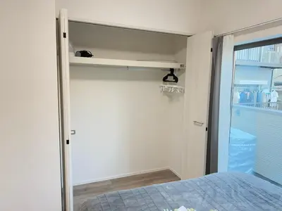 a bedroom with a bed and a sliding glass door at Ikebukuro Area 2 Units 2122 KamiikeApartment in Tokyo