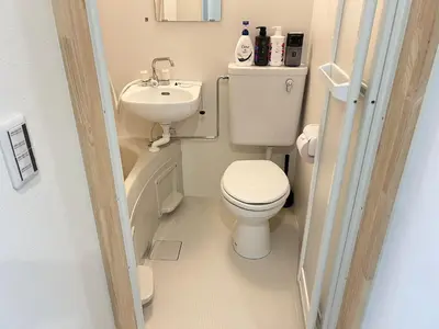 a small bathroom with a toilet and a sink at Ikebukuro Area 2 Units 2122 KamiikeApartment in Tokyo