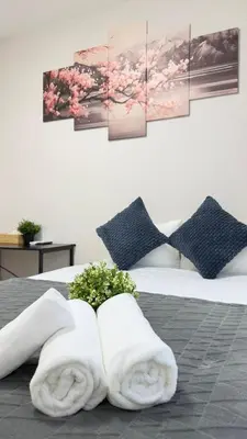 a bedroom with two towels on a bed with flowers at Ikebukuro Area 2 Units 2122 KamiikeApartment in Tokyo