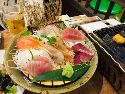 a plate of food with sushi on a table at Maison Okuasakusa in Tokyo