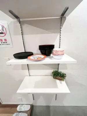 a white shelf with bowls and pans on it at Yotsugi Hotel Asakusa Skytree in Tokyo