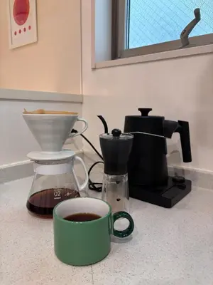 a coffee maker and a cup of coffee on a counter at Tokyo Bauhaus in Tokyo