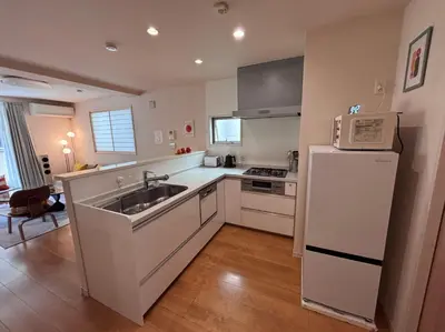 a kitchen with a sink and a refrigerator at Tokyo Bauhaus in Tokyo