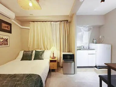 a hotel room with a bed and a kitchen at Tokyo Hakusan Louis Apartment near TOKYO DOME close to Yamanote Line in Tokyo