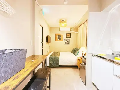 a hotel room with a bed and a kitchen at Tokyo Hakusan Louis Apartment near TOKYO DOME close to Yamanote Line in Tokyo