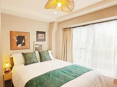 a bedroom with a bed and a window at Tokyo Hakusan Louis Apartment near TOKYO DOME close to Yamanote Line in Tokyo