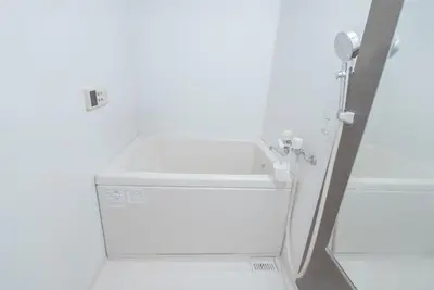 a white washing machine in a white room at 1 minute from Higashi-Shinjuku Station Large living room in Tokyo