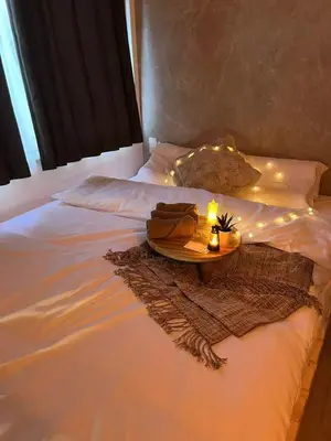 a white bed with a tray with a candle on it at jr\u5e73\u4e95\u7ad9\u53ea\u9700\u5f92\u6b65\u4e94\u5206\u949f\u4e09\u4e2a\u623f\u95f4\u4e00\u6237\u5efa\u53ef\u4f9b6\u4eba\u5165\u4f4f in Tokyo