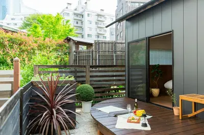 a patio with a wooden table on a balcony at HOTEL RIN TOKYO - Private Townhouse - in Tokyo