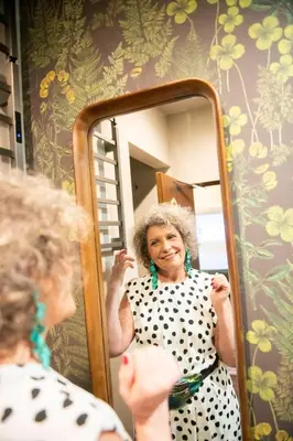 a woman standing in front of a mirror at HOTEL RIN TOKYO - Private Townhouse - in Tokyo