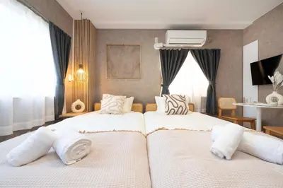 a bedroom with two beds with white pillows at All Good Stay HEIWAJIMA in Tokyo