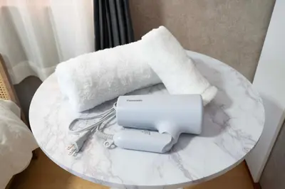 a white table with a printer and a roll of paper at All Good Stay HEIWAJIMA in Tokyo