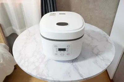 a white coffee maker on a marble table at All Good Stay HEIWAJIMA in Tokyo