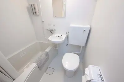 a white bathroom with a toilet and a sink at All Good Stay HEIWAJIMA in Tokyo