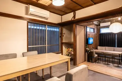 a room with a table and chairs and a dining room at t plus house ryogoku in Tokyo