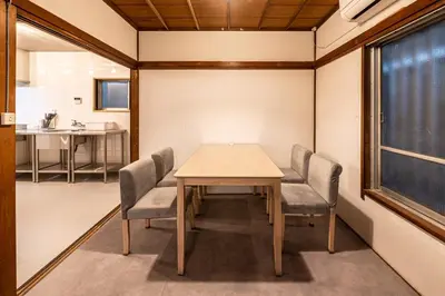 a dining room with a table and chairs at t plus house ryogoku in Tokyo