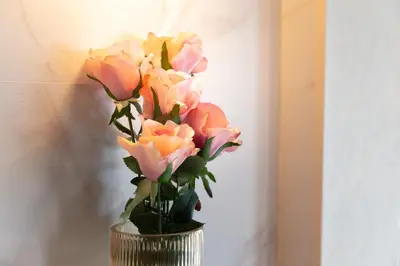 a vase filled with pink and orange roses at Five Roses House in Tokyo
