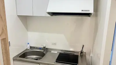 a small kitchen with a sink and white cabinets at Ikebukuro Area 1F3 KamiikeApartment in Tokyo