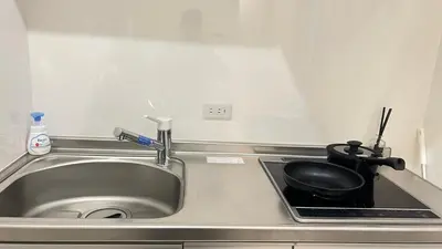 a kitchen sink with a frying pan and a pot at Ikebukuro Area 1F3 KamiikeApartment in Tokyo