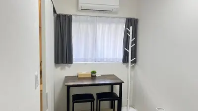 a small table with two chairs and a window at Ikebukuro Area 1F3 KamiikeApartment in Tokyo