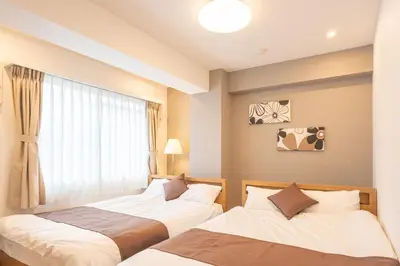 two beds in a room with a window at Nestry Asakusa 403\u53f7\u5ba4 in Tokyo