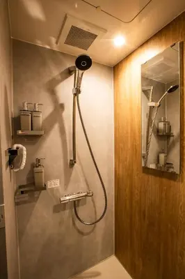 a shower in a bathroom with a shower head at Nestry Asakusa 403\u53f7\u5ba4 in Tokyo