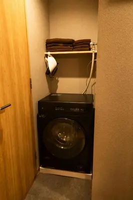 a black washer and dryer in a room at Nestry Asakusa 403\u53f7\u5ba4 in Tokyo
