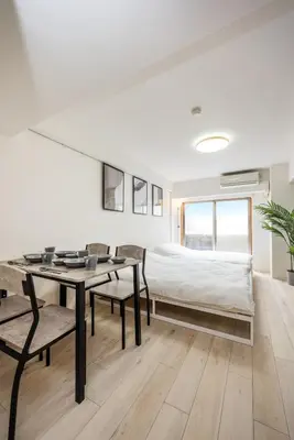 a bedroom with a bed and a table and chairs at 20 minutes by Haneda Airport train 3-minute walk from Kamata Station Direct access to Tokyo, Yokohama, Ueno in Tokyo